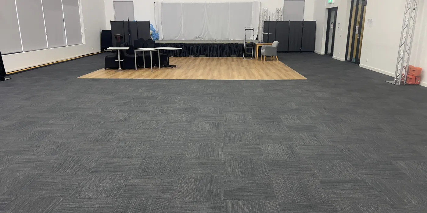 The same Laverton function hall after cleaning, looking toward the stage and dance floor.