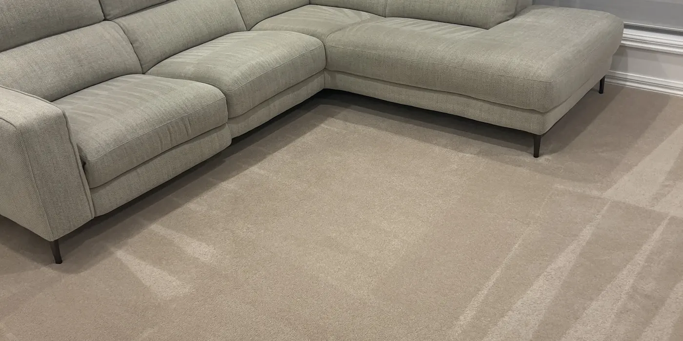 Freshly cleaned lounge carpet around a corner sofa on a real Green Lion job across Melbourne's west