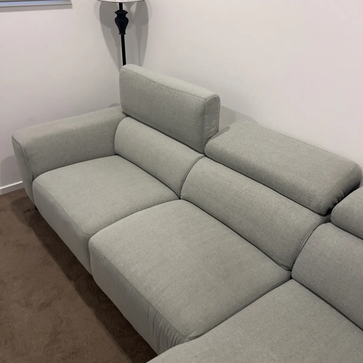 Light-grey modular fabric sofa after a Green Lion upholstery clean.