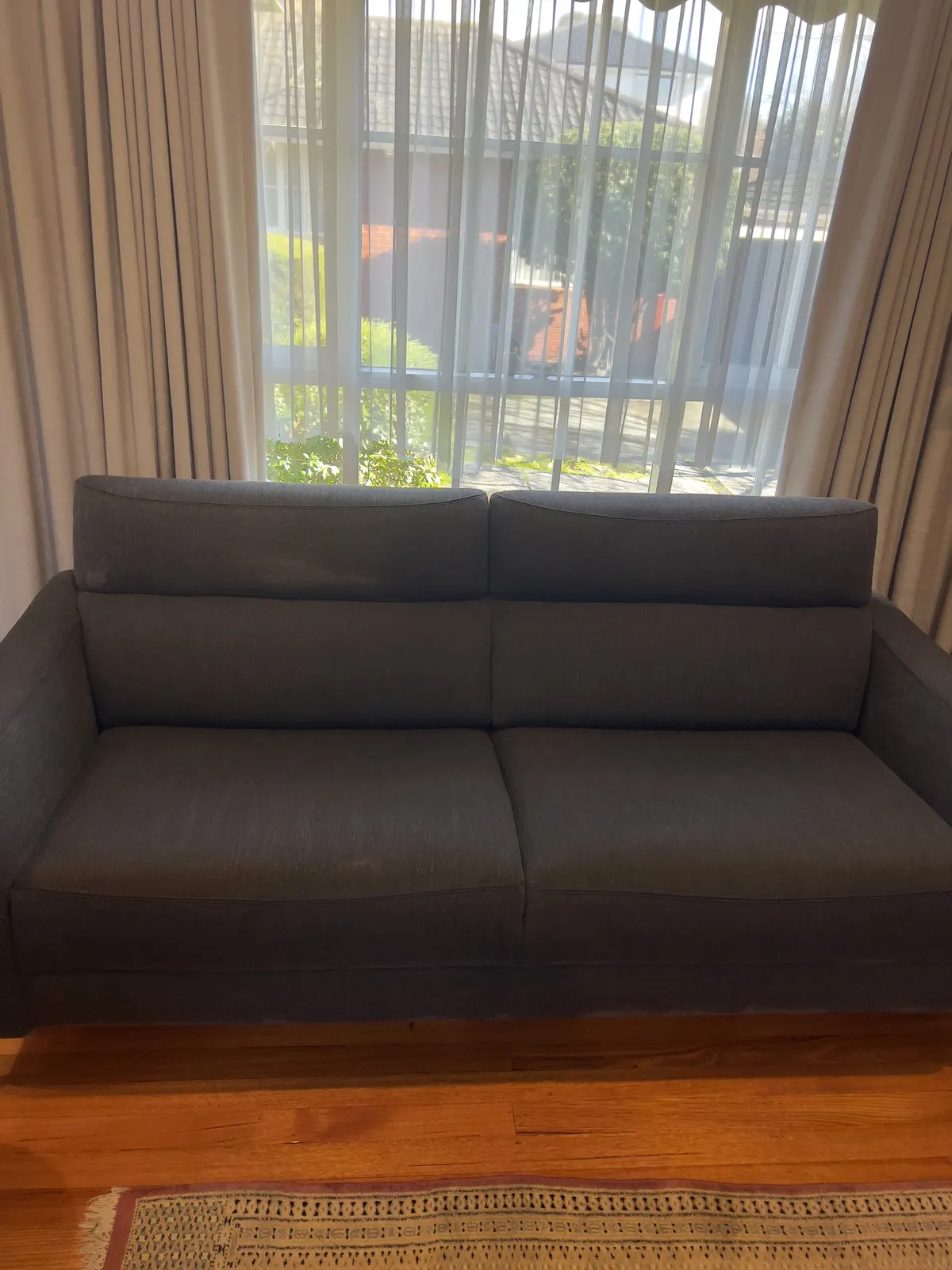 Grey fabric two-seater after a Green Lion couch clean, back in the front room