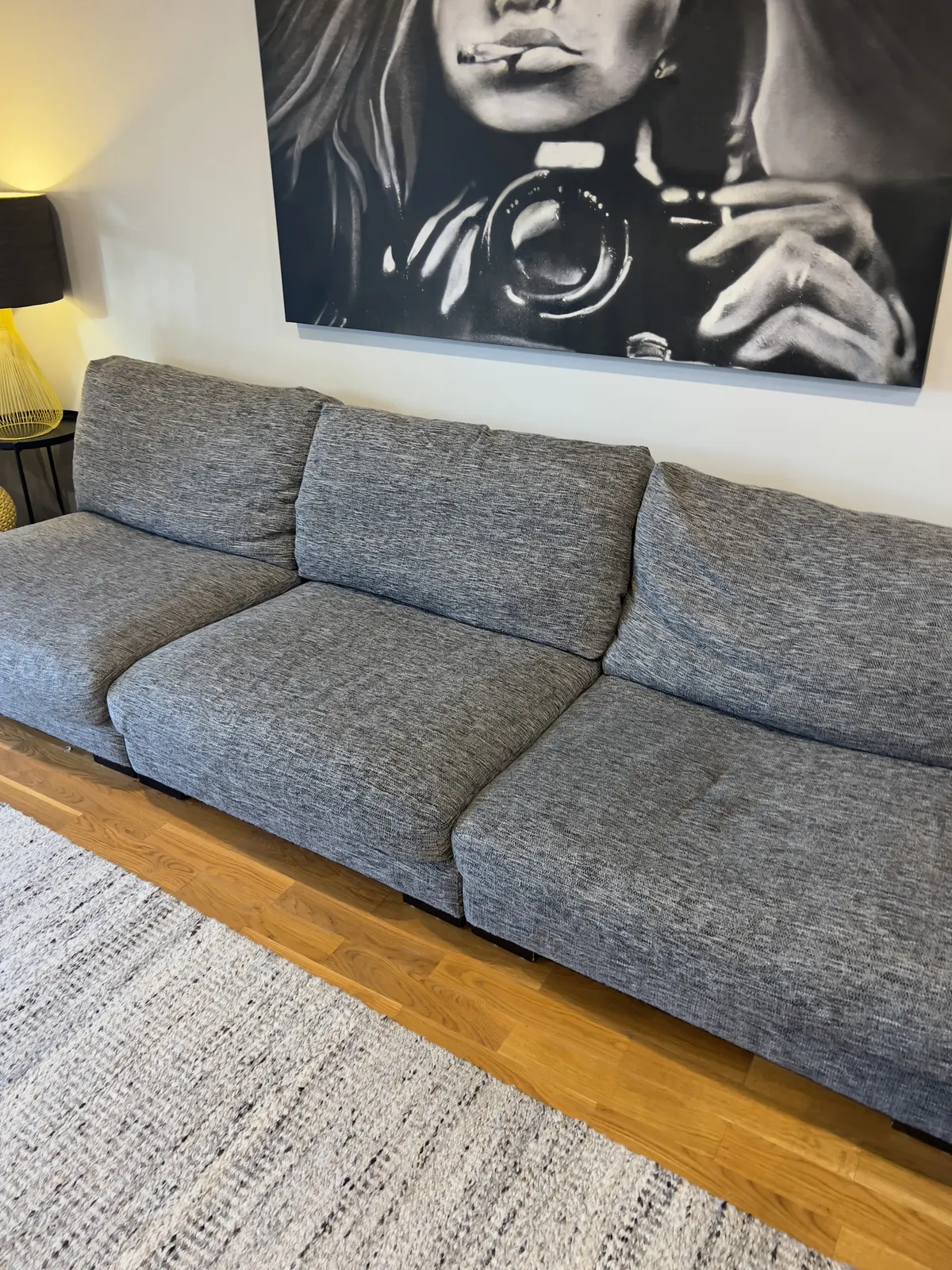 Grey fabric three-seater sofa after cleaning on the same Werribee job.