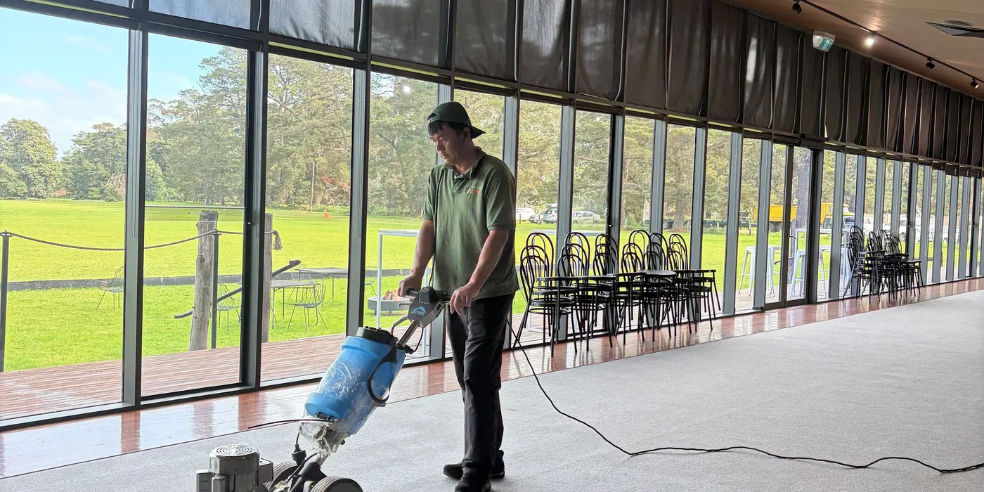 Jin from Green Lion cleaning the function-room carpet at Lancemore Mansion, Werribee Park, with a low-moisture rotary machine