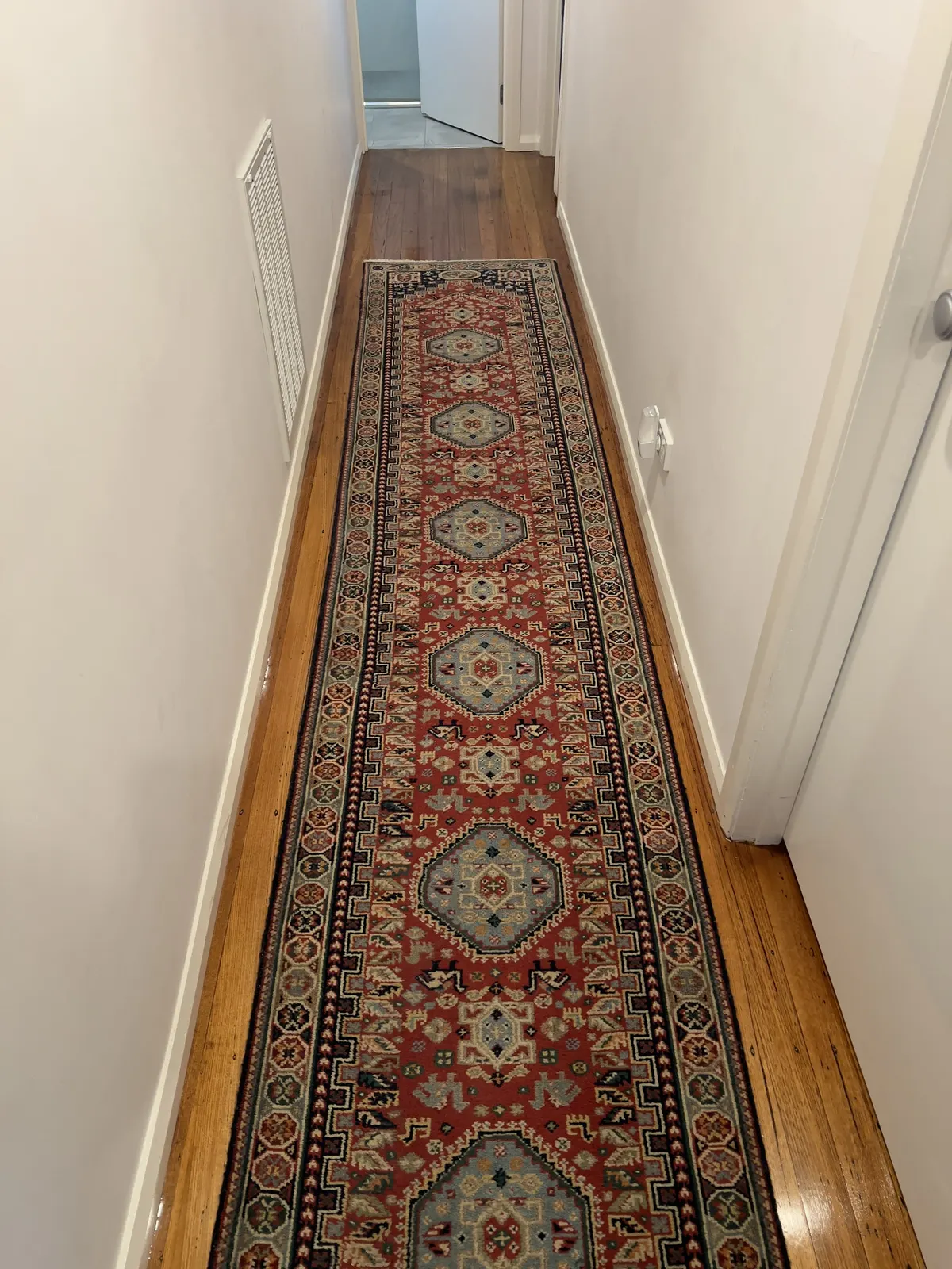 Patterned hallway runner after a Green Lion rug clean, back on the timber floorboards