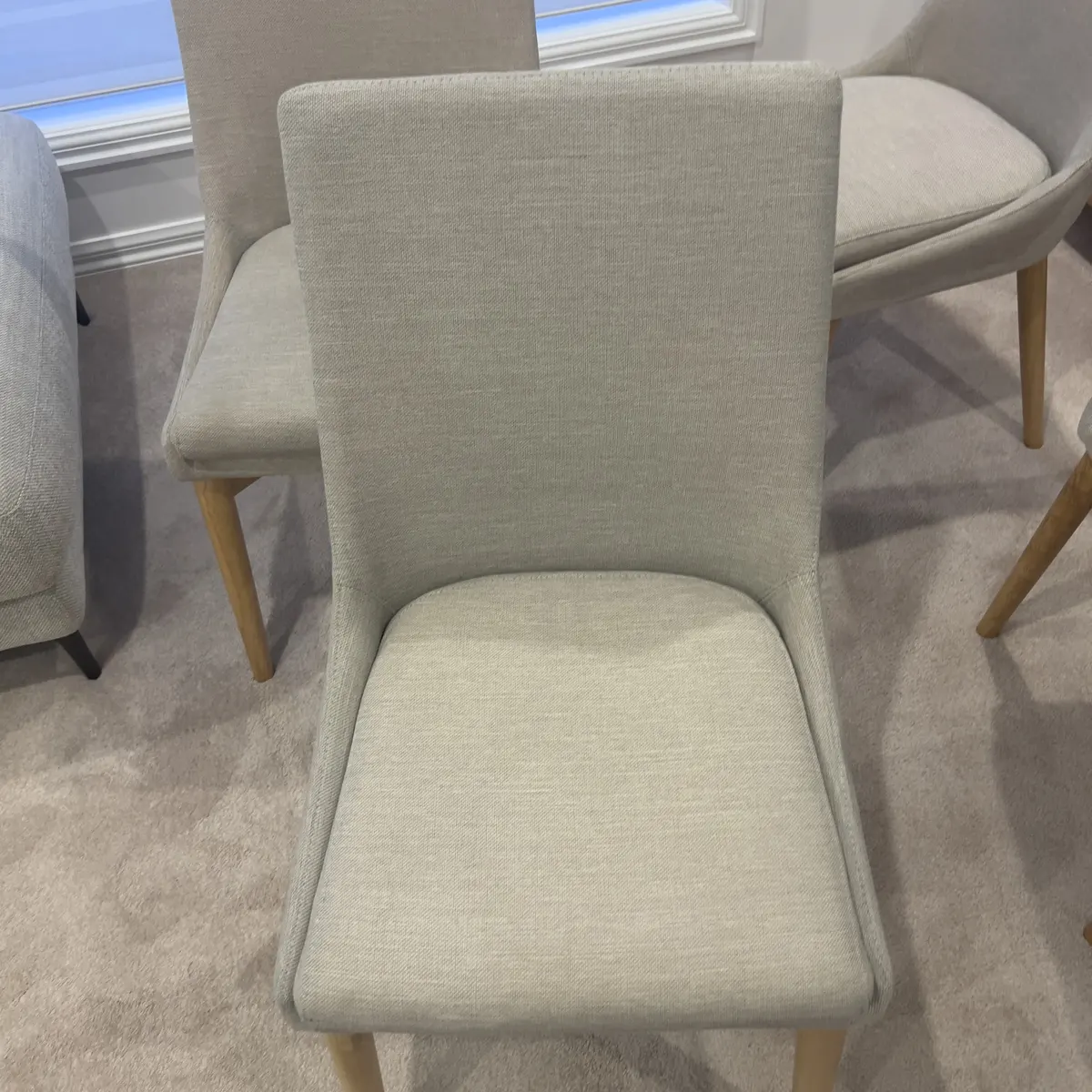 Upholstered dining chair after a Green Lion fabric clean — the seat and back cleaned in place