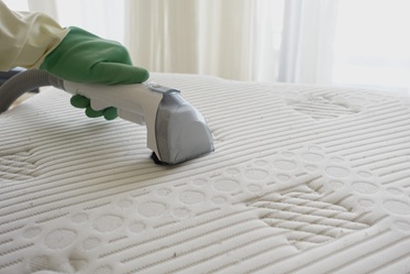 Matress Cleaning A mattress being cleaned to remove dirt and bacteria build up.